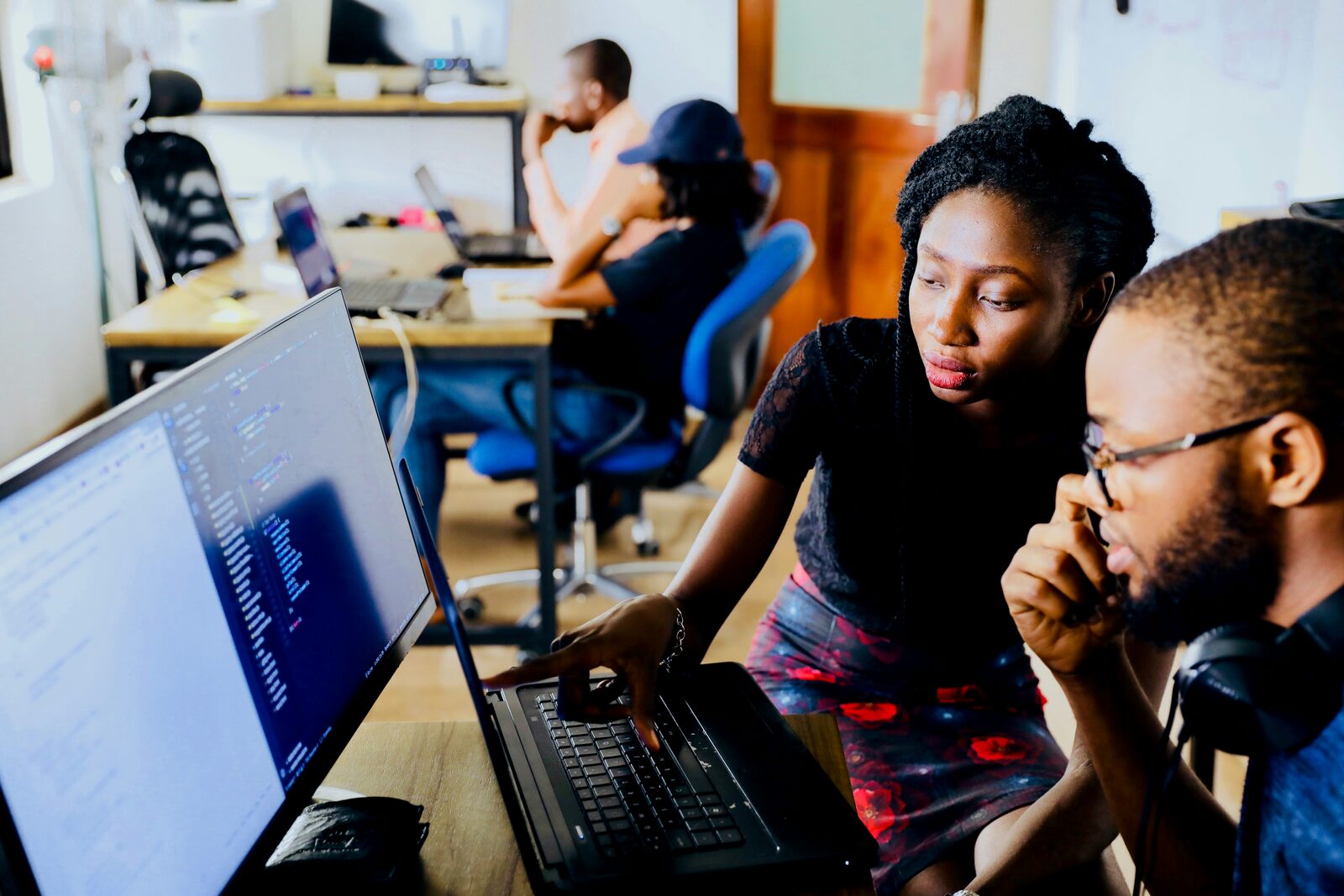 Two Hewani team members reviewing code together